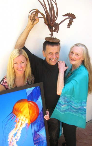 Photo by Mike Tauber From left, mixed media artist Carrie Zeller, found object artist Shamus Koch  and textile designer Olivia Batchelder show off their donations to the Sawdust Festival auction.